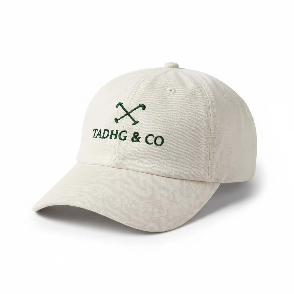 Cream Baseball Cap (dad cap style) with green Tadhg & Co branding. 