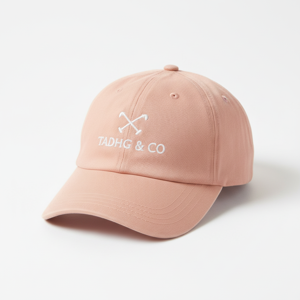 Peach Baseball Cap (dad cap style) with white Tadhg & Co branding. 